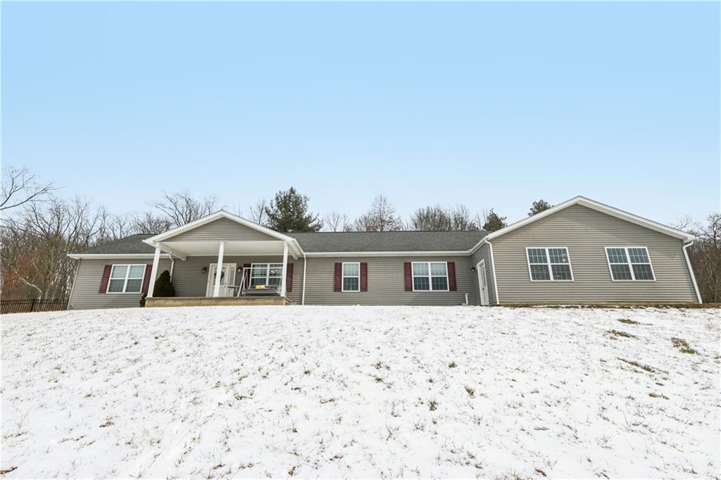 224 Toy Road Kittanning, PA 16201 - Photo 2 of 48 a front view of a house with a yard covered in snow