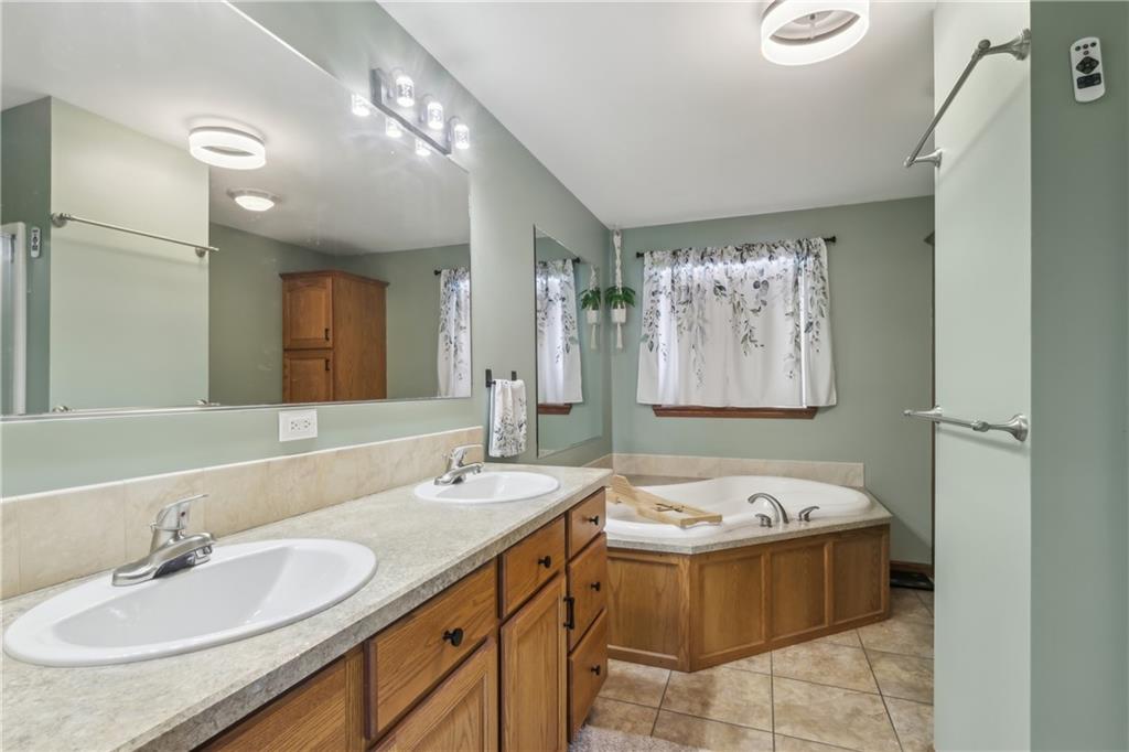 224 Toy Road Kittanning, PA 16201 - Photo 25 of 48 a bathroom with a tub sink and mirror