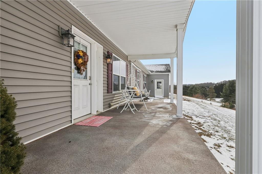 224 Toy Road Kittanning, PA 16201 - Photo 5 of 48 a view of a patio with table and chairs and floor to ceiling window