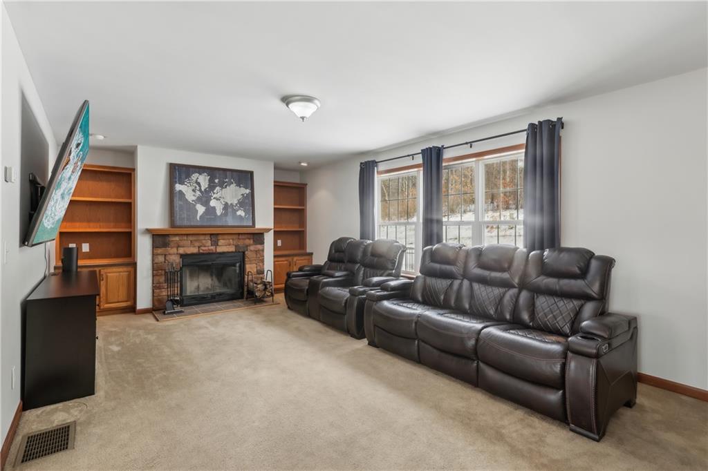 224 Toy Road Kittanning, PA 16201 - Photo 9 of 48 a living room with furniture a flat screen tv and a fireplace