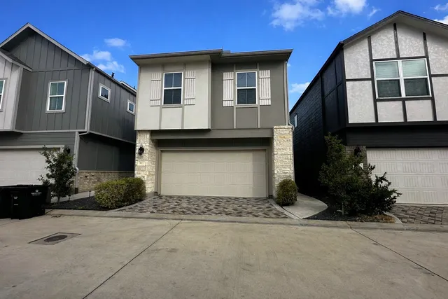 a kitchen with stainless steel appliances granite countertop a refrigerator a sink and white cabinets
