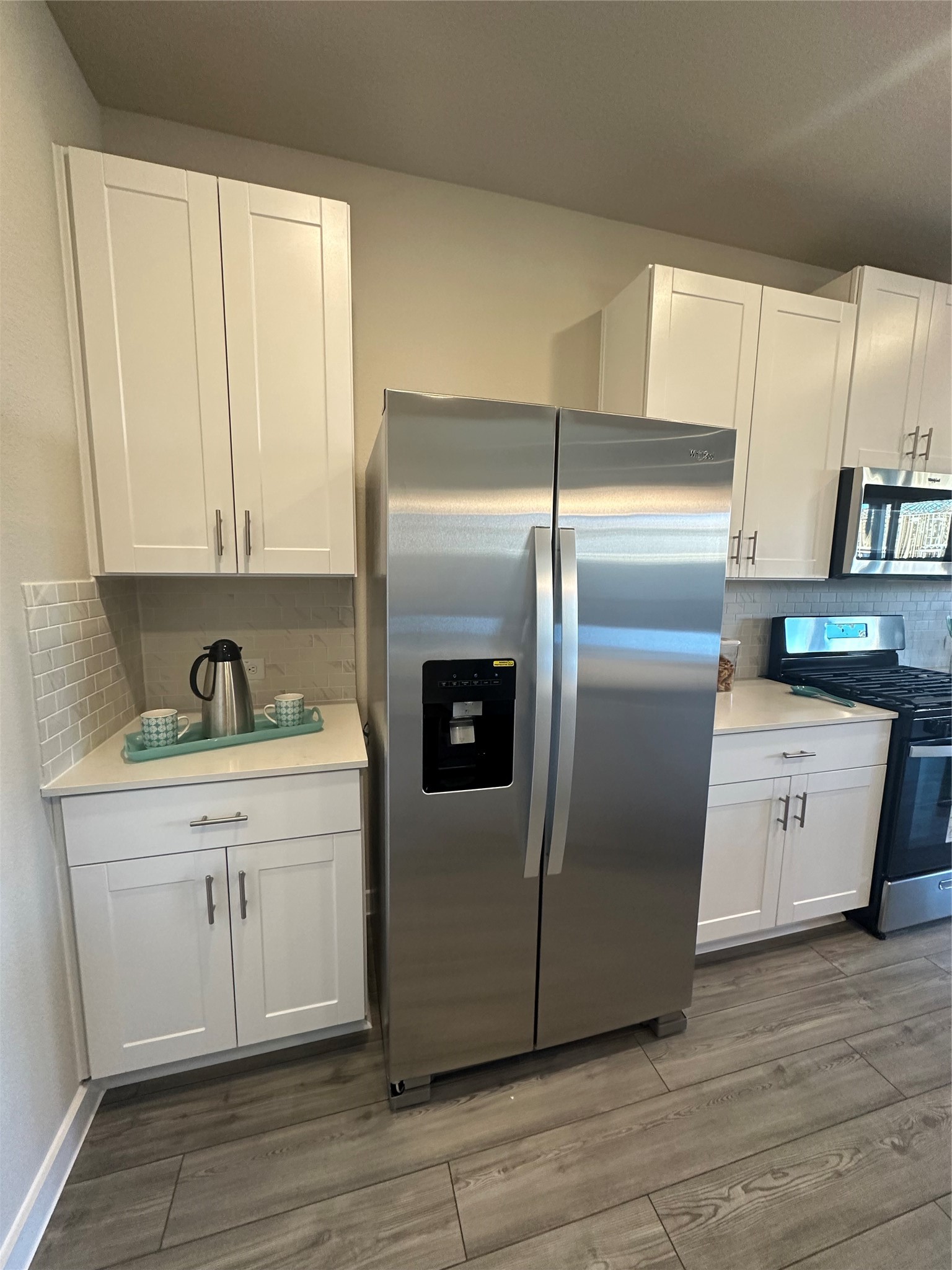 3113 Moontide Lane Houston, TX 77063 - Photo 7 of 39 a kitchen with stainless steel appliances granite countertop a refrigerator a sink and white cabinets