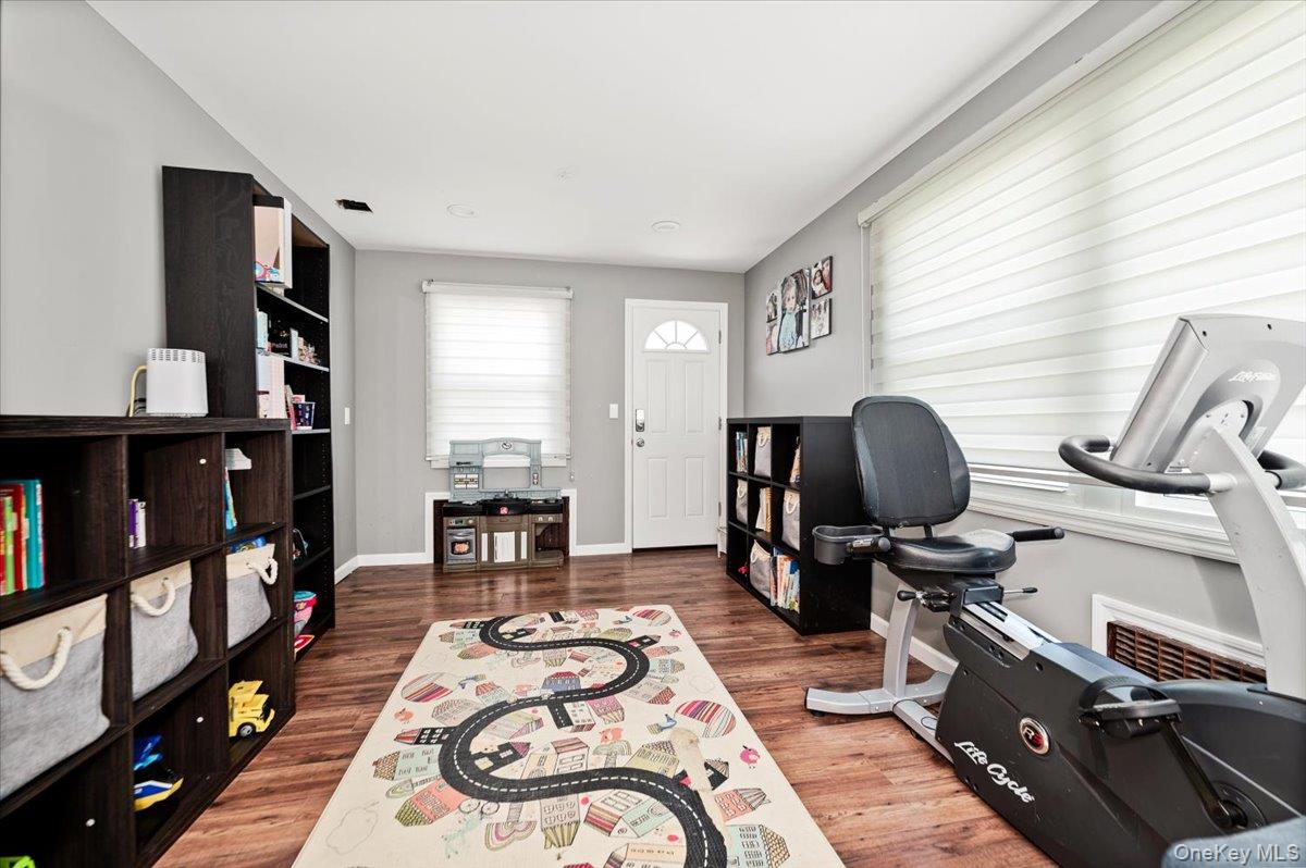 534 Allen Road Woodmere, NY 11598 - Photo 13 of 35 a room with furniture a flat screen tv and a fireplace