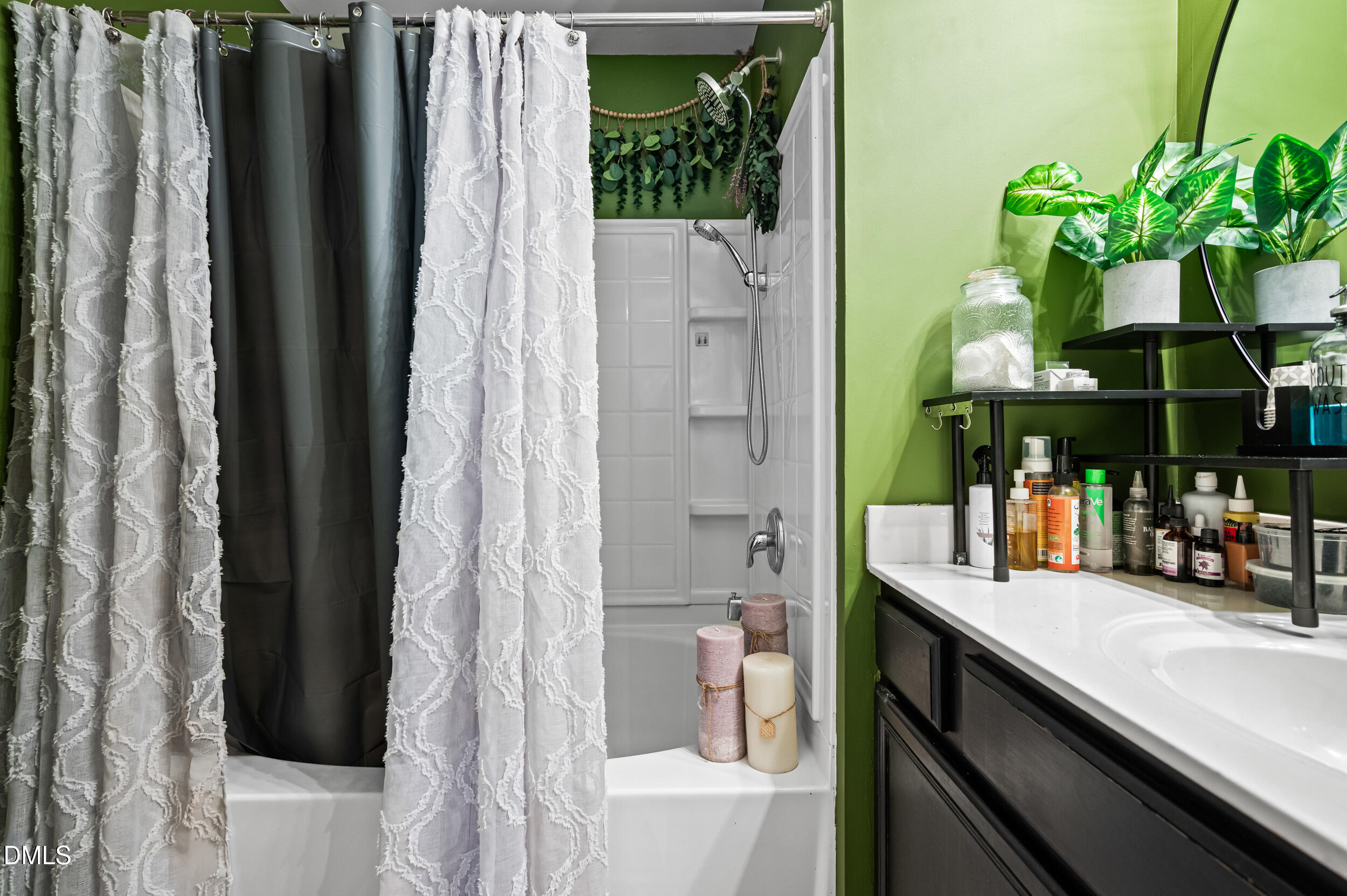 2944 Casona Way Raleigh, NC 27616 - Photo 16 of 24 a bathroom with a sink a mirror and a shower