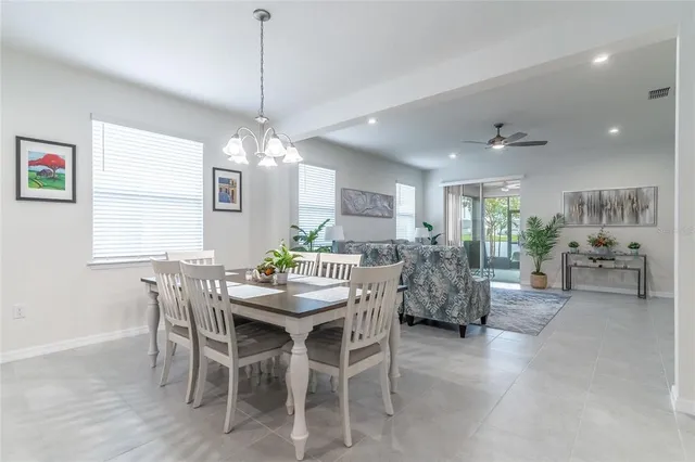 a kitchen with kitchen island a dining table and chairs