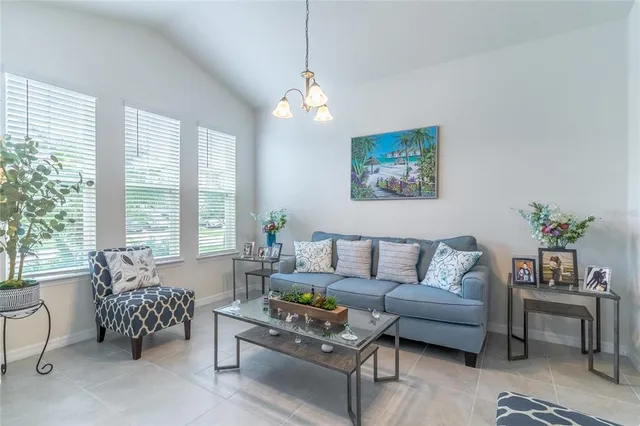 a living room with furniture and a chandelier