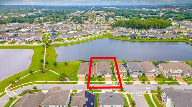 an aerial view of residential house with pool and yard