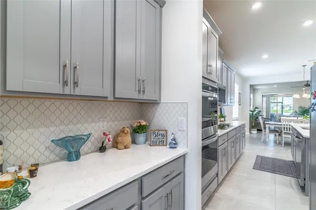 a kitchen with appliances a sink a counter top space and cabinets