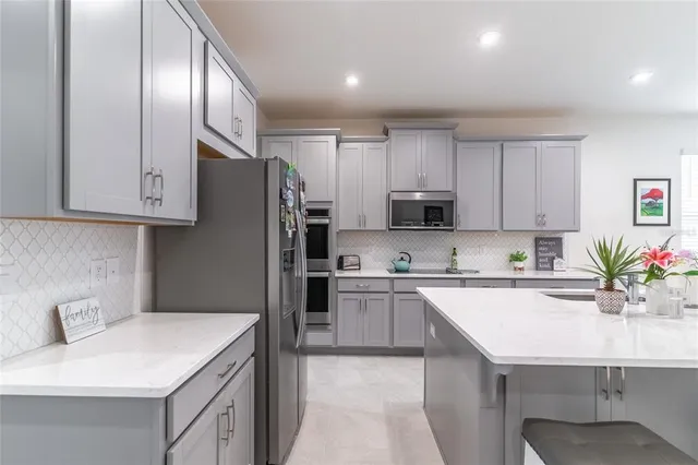 a kitchen with stainless steel appliances granite countertop a sink stove and cabinets