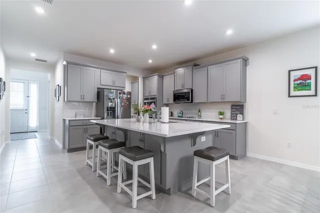 a kitchen with lots of clutter and cabinets