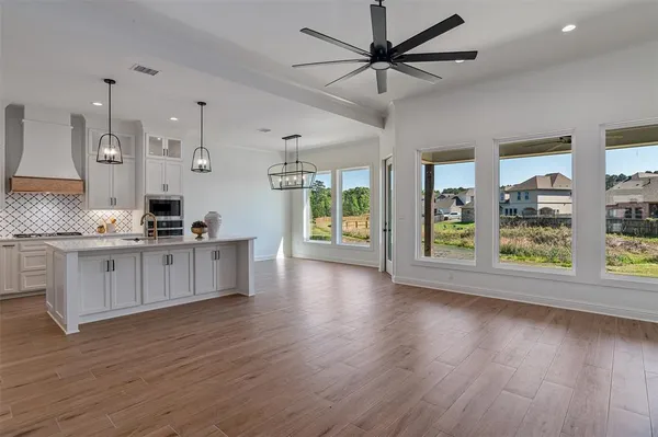 a view of kitchen with wooden floor and electronic appliances