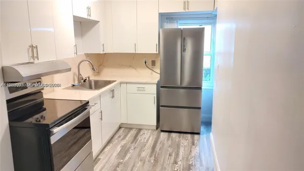 a kitchen with appliances cabinets and a sink
