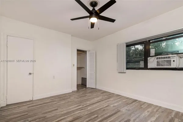 a view of a livingroom with a ceiling fan and wooden floor