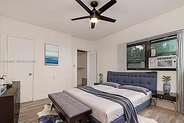 a bedroom with a bed and a window