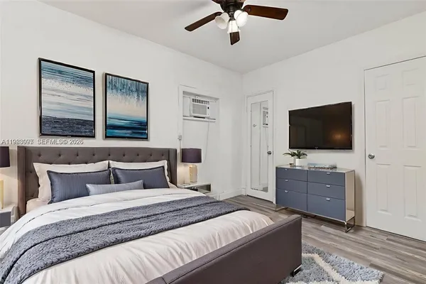 a bedroom with a bed and a flat screen tv