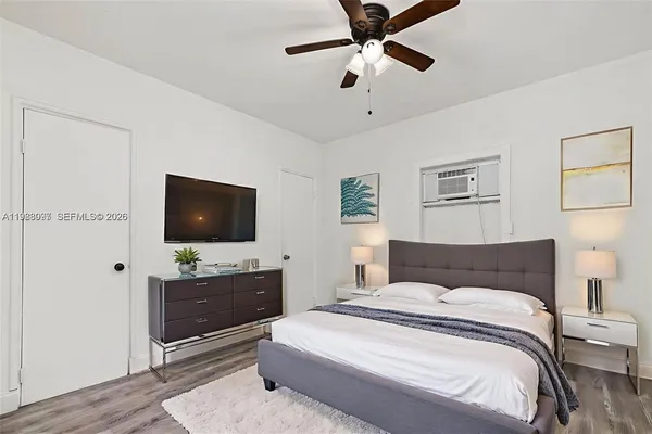 a bedroom with a large bed and a flat screen tv