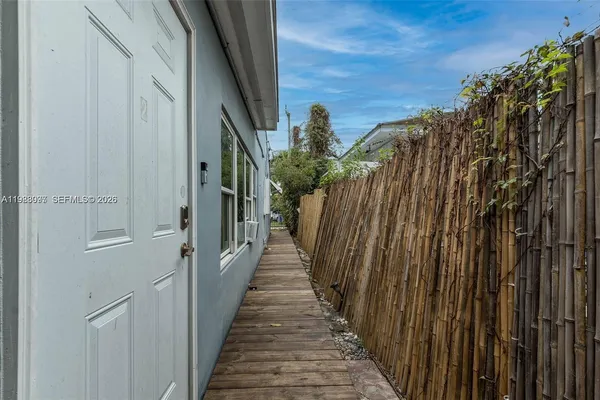 a view of a pathway of a building with wooden fence