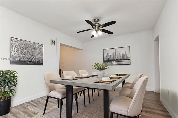 a view of a dining room with furniture and wooden floor