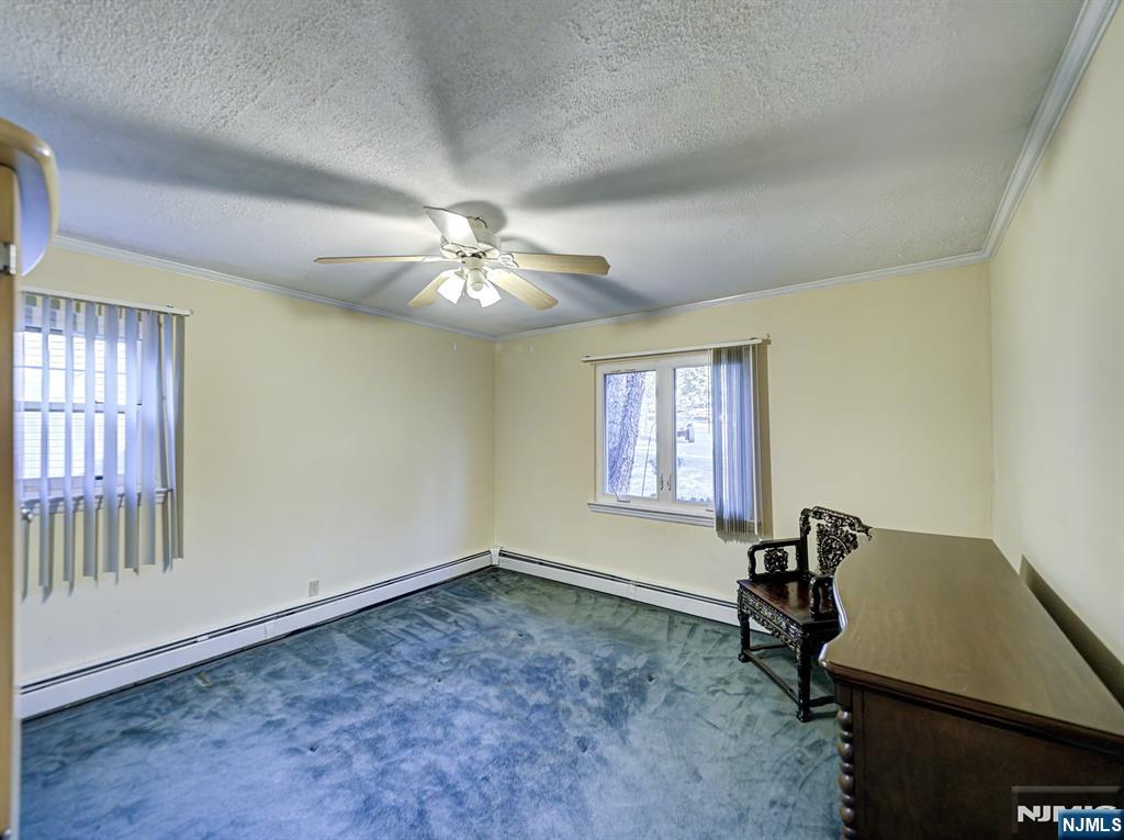 59 David Road Cedar Grove, NJ 07009 - Photo 11 of 24 a view of a livingroom with a piano and wooden floor