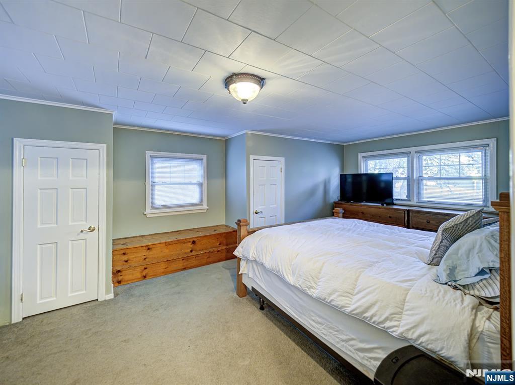 59 David Road Cedar Grove, NJ 07009 - Photo 14 of 24 a bedroom with a bed and a dresser next to a window