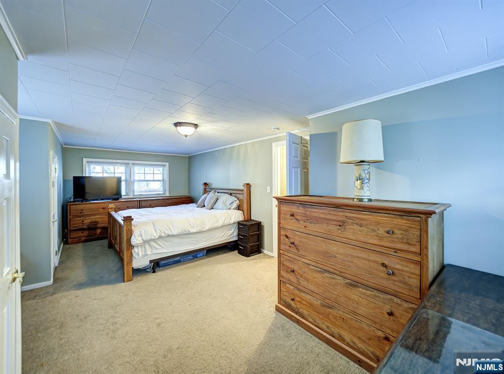 59 David Road Cedar Grove, NJ 07009 - Photo 15 of 24 a bedroom with a bed and a night stand