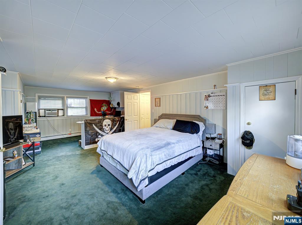 59 David Road Cedar Grove, NJ 07009 - Photo 18 of 24 a spacious bedroom with a bed and a flat screen tv