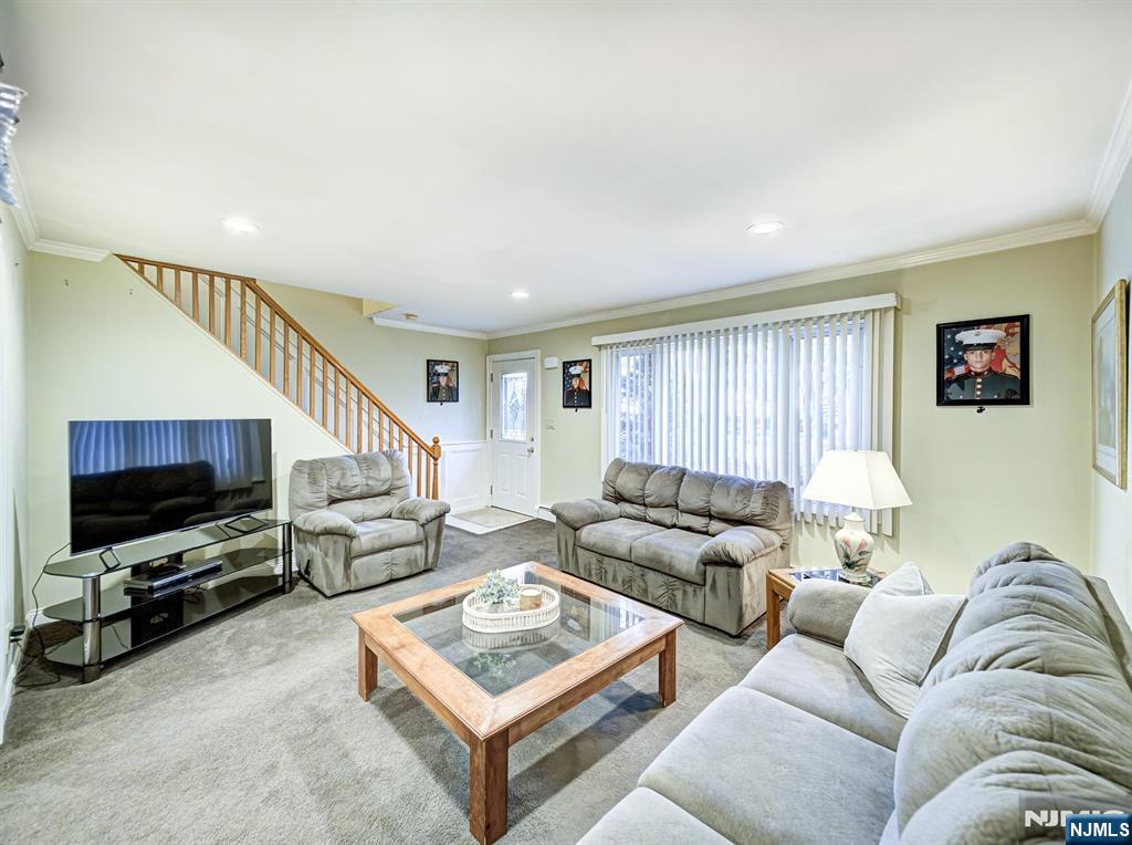 59 David Road Cedar Grove, NJ 07009 - Photo 2 of 24 a living room with furniture and a flat screen tv