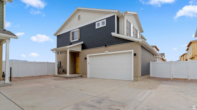 Contemporary-style residence featuring a two-story design with a prominent attached garage