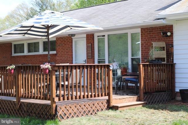 7410 Inzer Street Springfield, VA 22151 - Photo 2 of 30 a view of a house with wooden deck and a yard