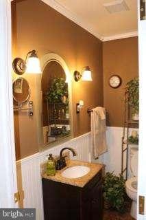 7410 Inzer Street Springfield, VA 22151 - Photo 15 of 30 a bathroom with a granite countertop sink and a mirror