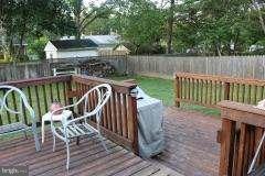 7410 Inzer Street Springfield, VA 22151 - Photo 19 of 30 a view of a wooden deck with furniture and a backyard