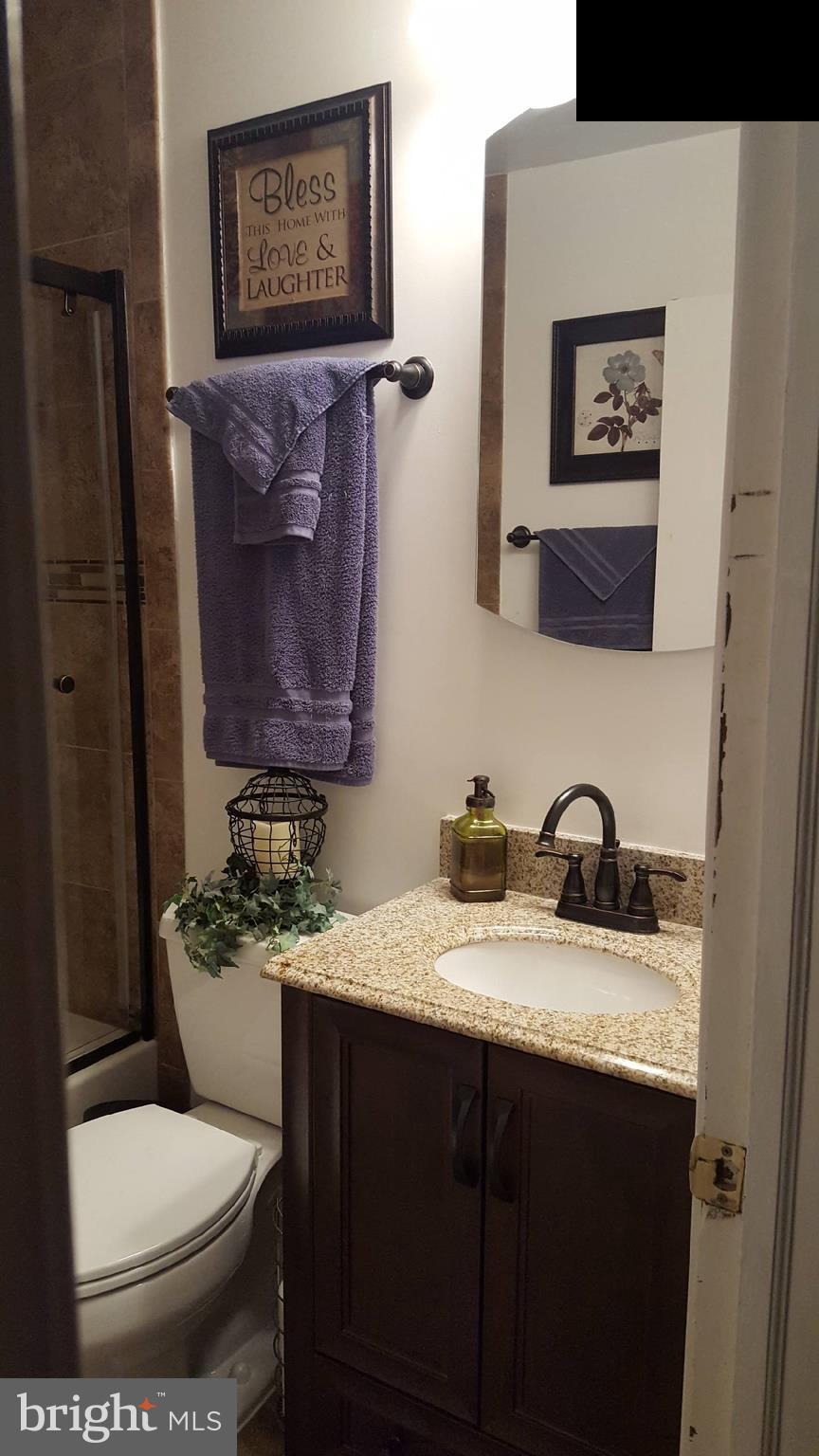 7410 Inzer Street Springfield, VA 22151 - Photo 3 of 30 a bathroom with a granite countertop toilet sink and mirror