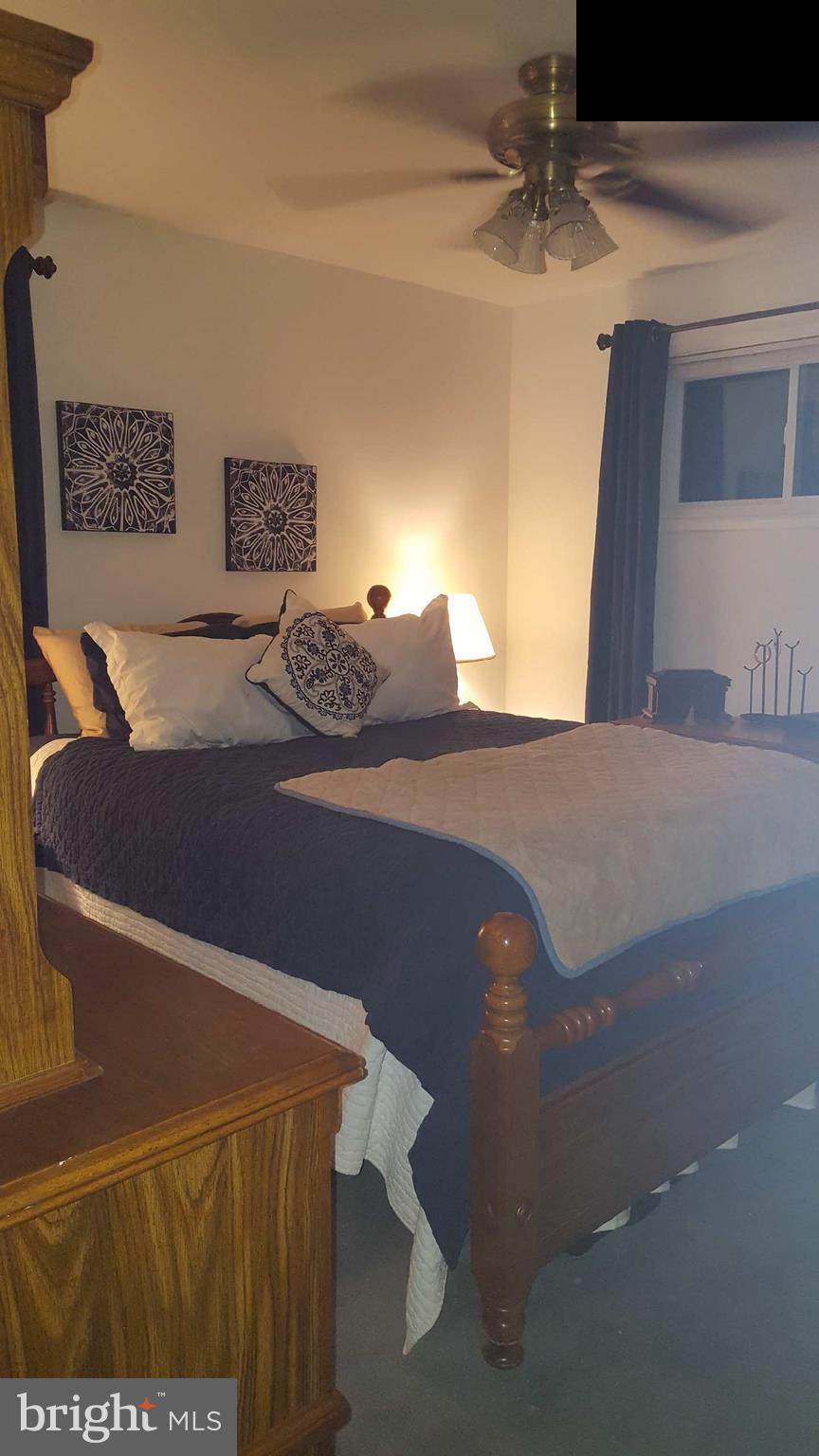 7410 Inzer Street Springfield, VA 22151 - Photo 5 of 30 a bedroom with a bed and lamp