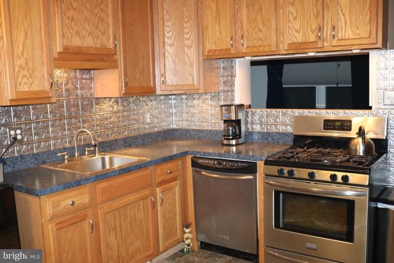 7410 Inzer Street Springfield, VA 22151 - Photo 6 of 30 a kitchen with granite countertop a stove top oven microwave and cabinets