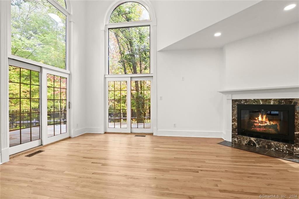 99 Wildwood Road Stamford, CT 06903 - Photo 1 of 1 a view of an empty room with wooden floor and a window