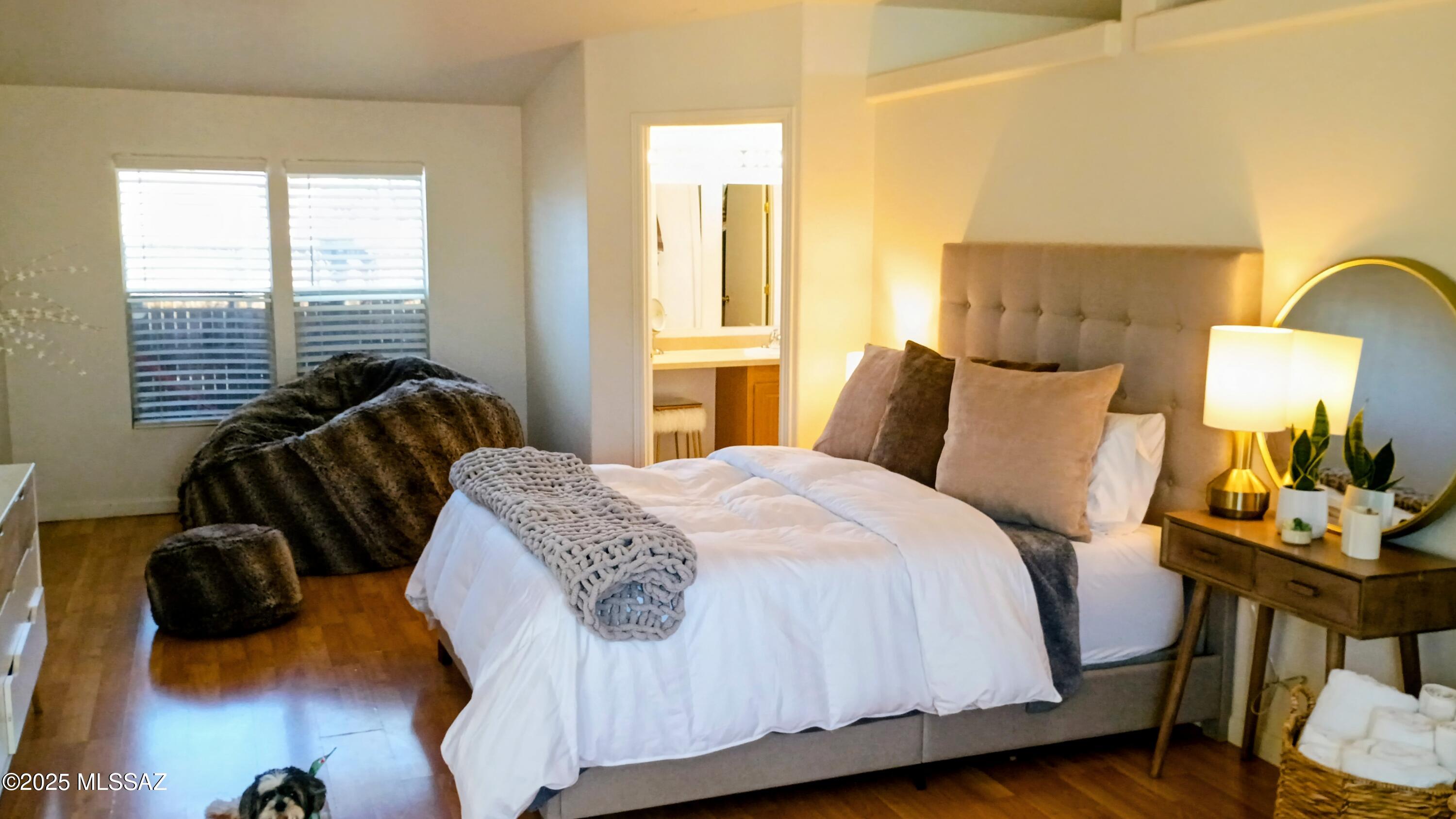 1449 West Hualpai Road Tucson, AZ 85745 - Photo 27 of 49 a bedroom with a bed and wooden floor