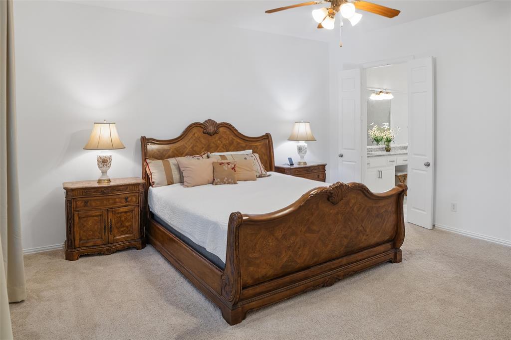 1818 Port Isabel Drive Allen, TX 75013 - Photo 16 of 38 a bed room with a bed and a chandelier