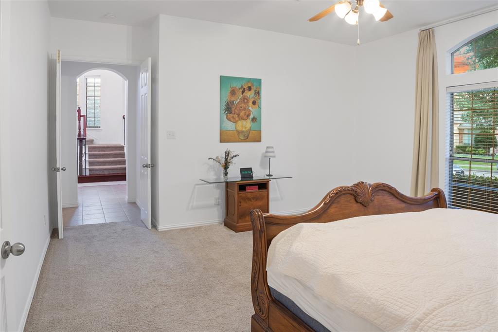 1818 Port Isabel Drive Allen, TX 75013 - Photo 19 of 38 a bedroom with a bed and a chandelier