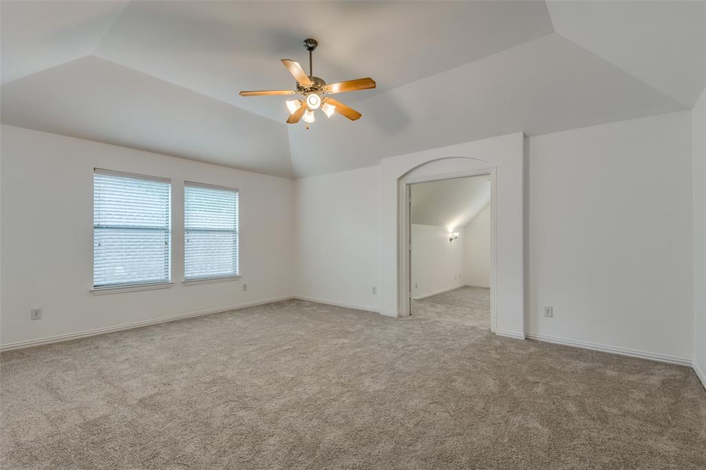 1818 Port Isabel Drive Allen, TX 75013 - Photo 21 of 38 an empty room with chandelier fan and windows