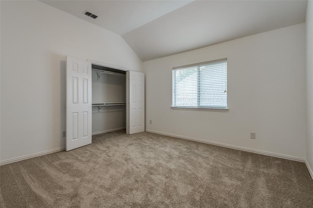 1818 Port Isabel Drive Allen, TX 75013 - Photo 22 of 38 an empty room with closet and windows