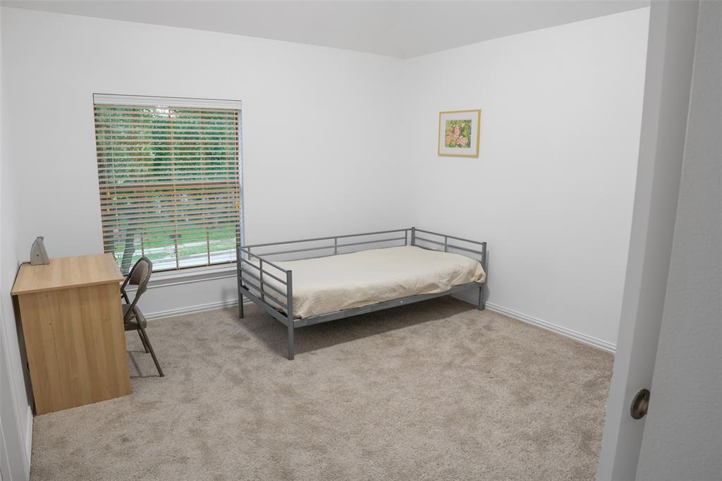 1818 Port Isabel Drive Allen, TX 75013 - Photo 24 of 38 a spacious bedroom with a bed and a window