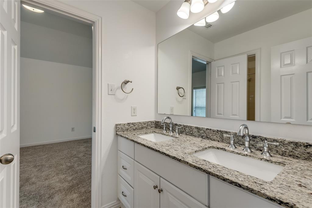 1818 Port Isabel Drive Allen, TX 75013 - Photo 26 of 38 a bathroom with a granite countertop sink and a mirror