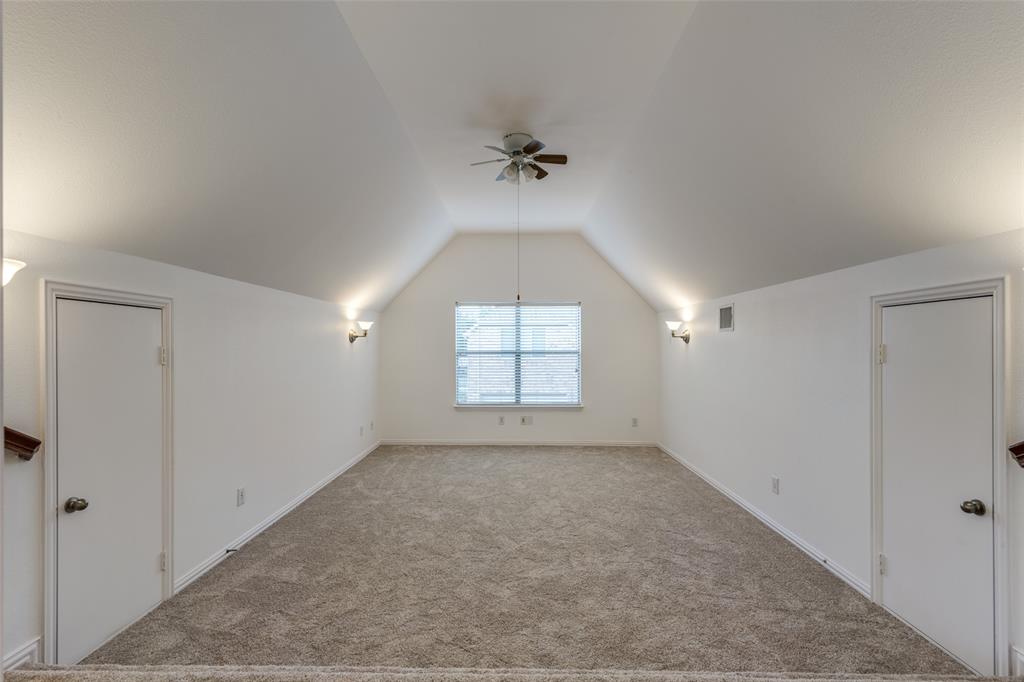 1818 Port Isabel Drive Allen, TX 75013 - Photo 28 of 38 an empty room with windows and a ceiling fan