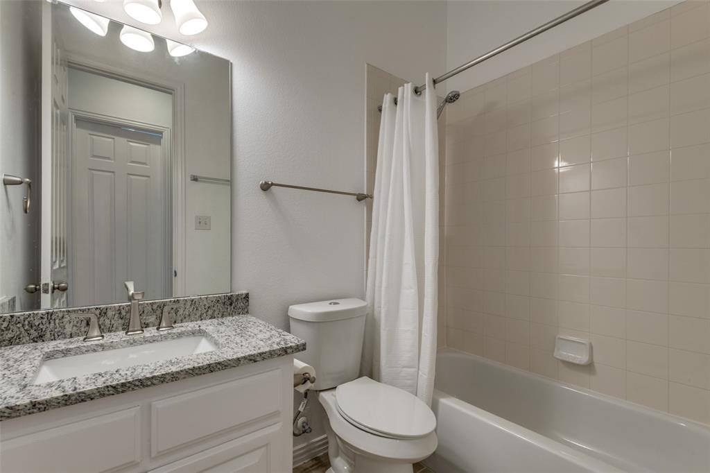 1818 Port Isabel Drive Allen, TX 75013 - Photo 33 of 38 a bathroom with a granite countertop sink toilet and shower