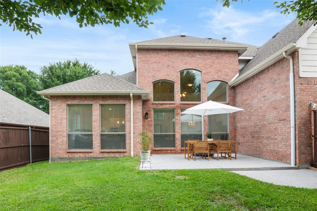 1818 Port Isabel Drive Allen, TX 75013 - Photo 36 of 38 a view of a chair and table in backyard of the house