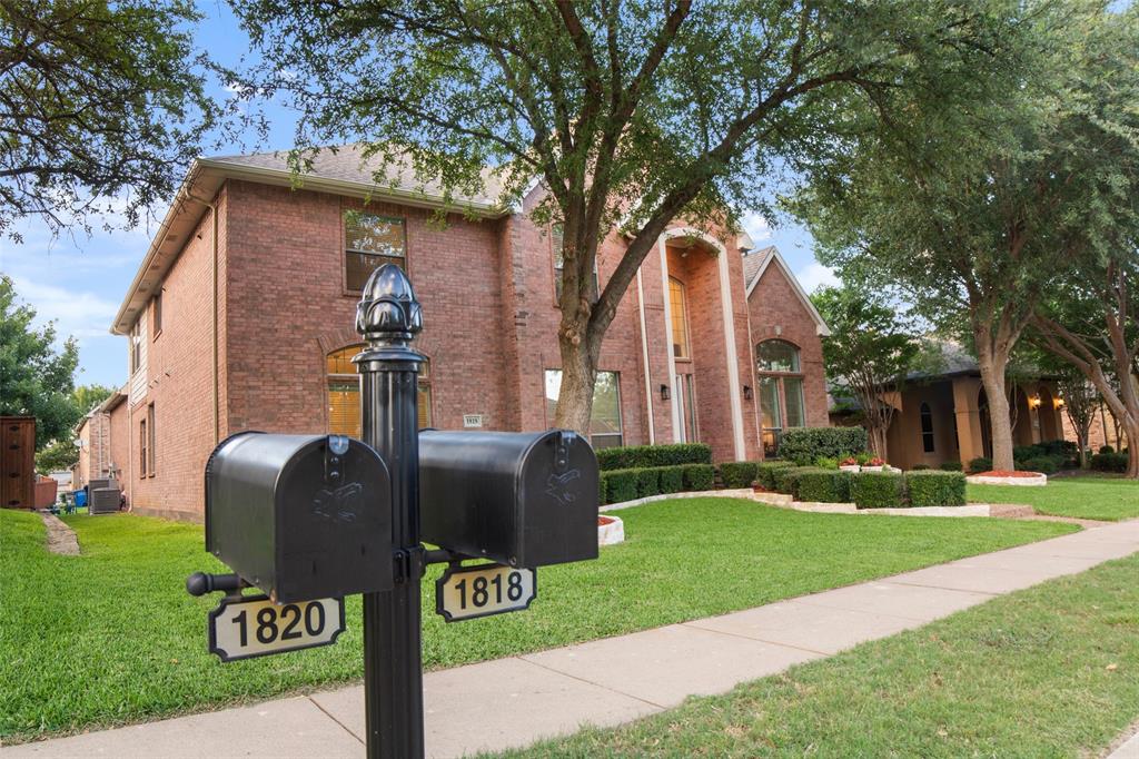 1818 Port Isabel Drive Allen, TX 75013 - Photo 37 of 38 a front view of a house with garden and trees