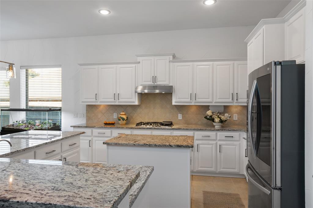 1818 Port Isabel Drive Allen, TX 75013 - Photo 6 of 38 a kitchen with stainless steel appliances granite countertop a refrigerator sink and stove