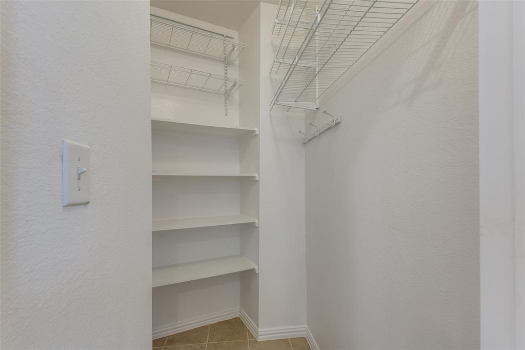 1818 Port Isabel Drive Allen, TX 75013 - Photo 9 of 38 a view of a store room with shelves