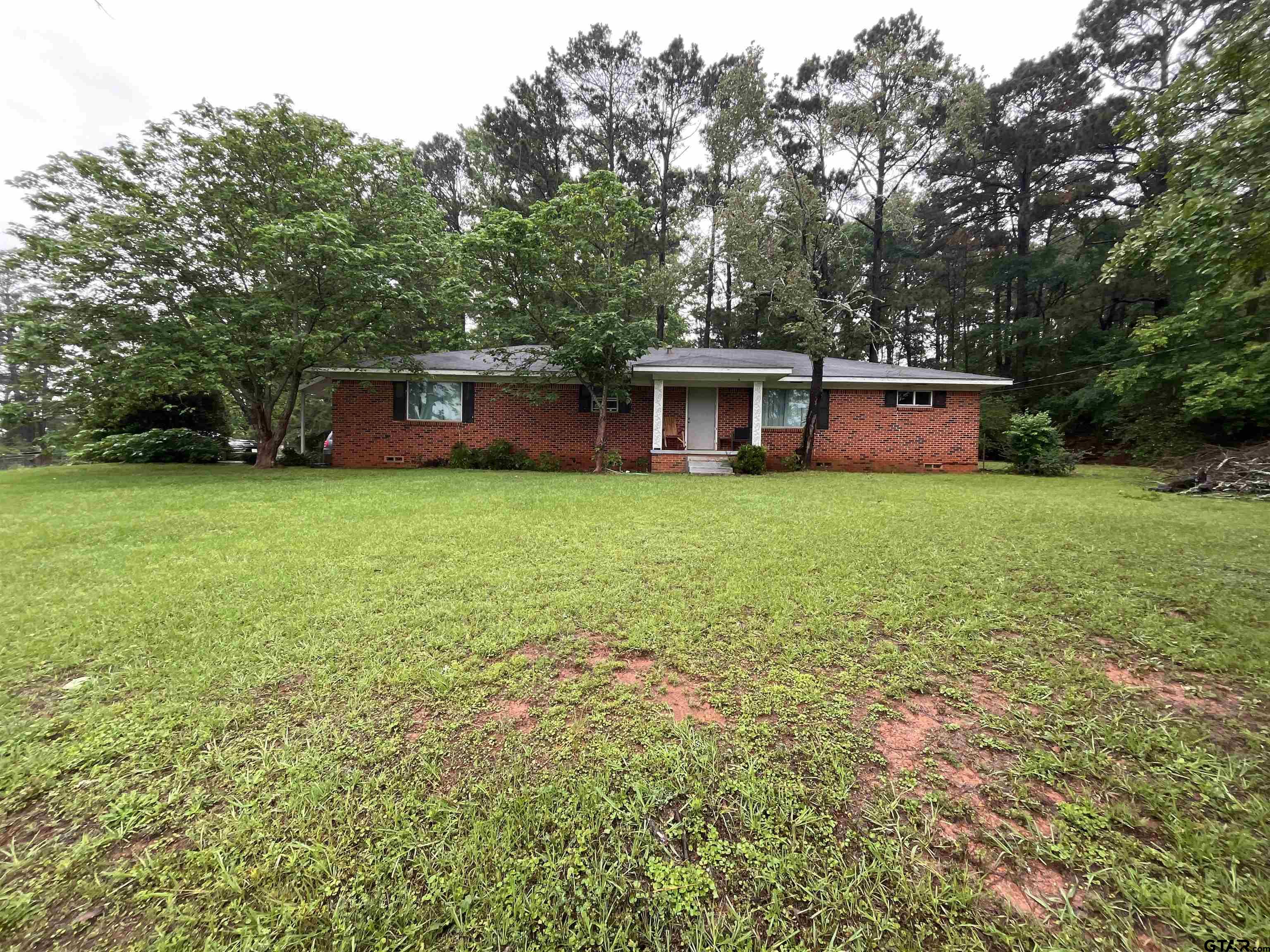 124 Pinecrest Drive North Rusk, TX 75785 - Photo 1 of 18 a house view with a garden space