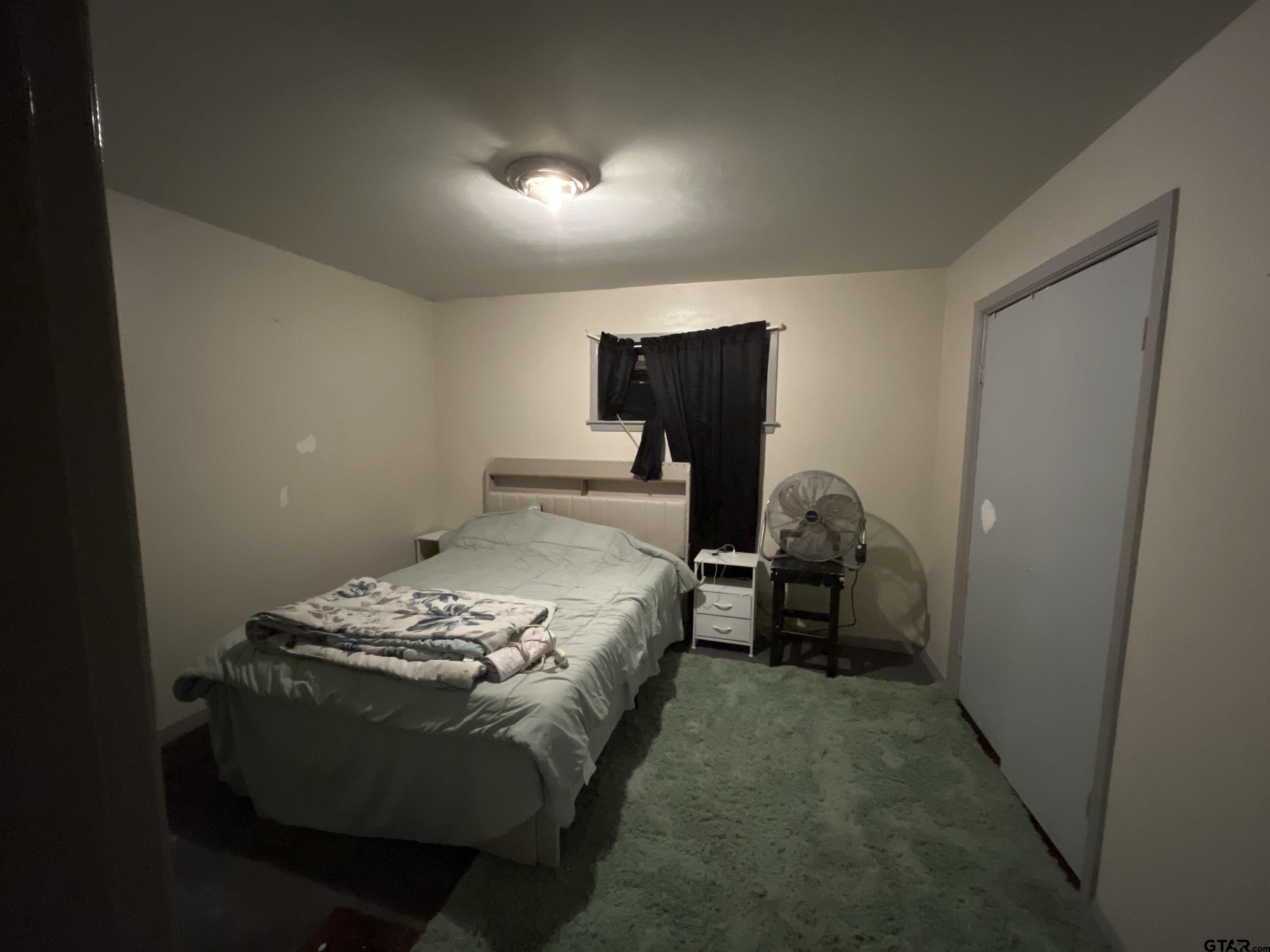 124 Pinecrest Drive North Rusk, TX 75785 - Photo 12 of 18 a bed sitting in a bedroom next to a window